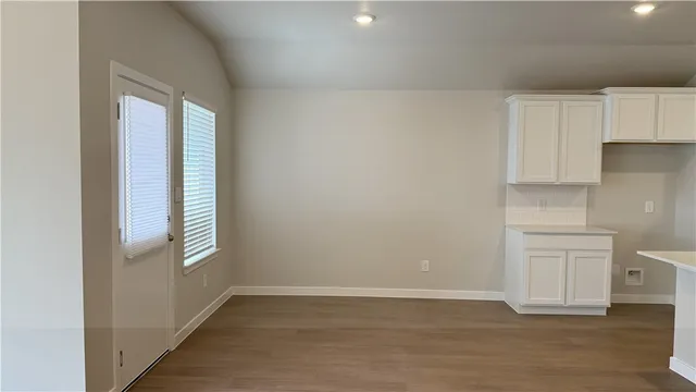 an empty room with a window and a ceiling fan