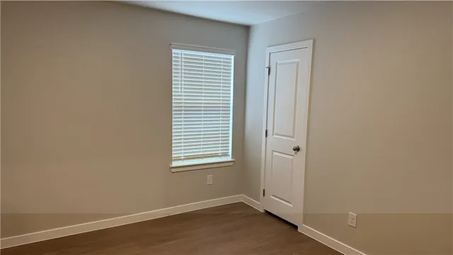 an empty room with wooden floor