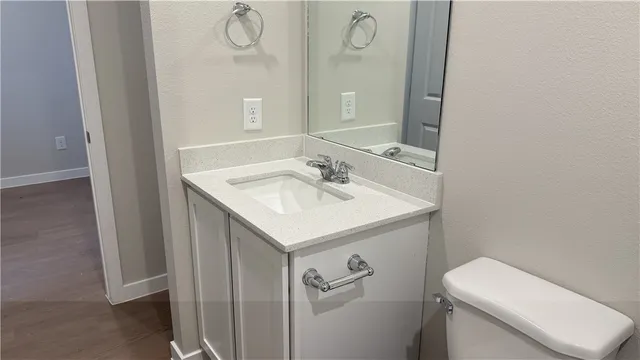 a view of a small space with wooden floor and a window