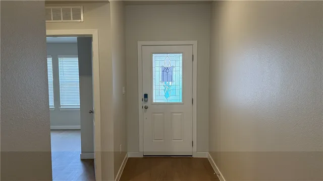 a view of small space with wooden floor and closet