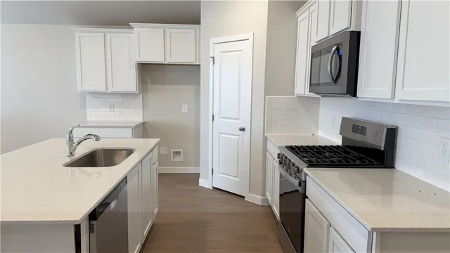 a stove top oven sitting inside of a kitchen