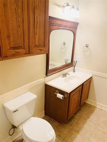 a bathroom with a sink a toilet and mirror