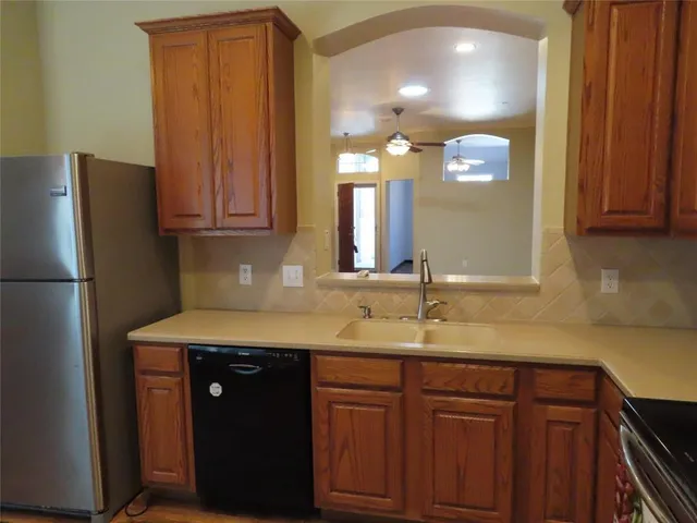 a kitchen with a sink and a refrigerator