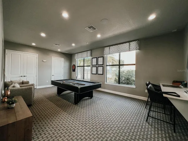 a living room with furniture a rug and a large window