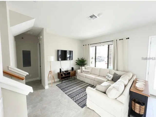 a living room with furniture and a flat screen tv
