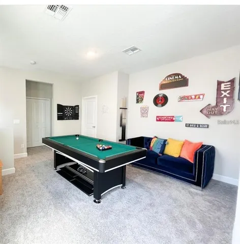 a room with furniture and wall paintings