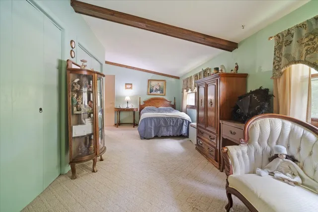 a bedroom with bed and a couch