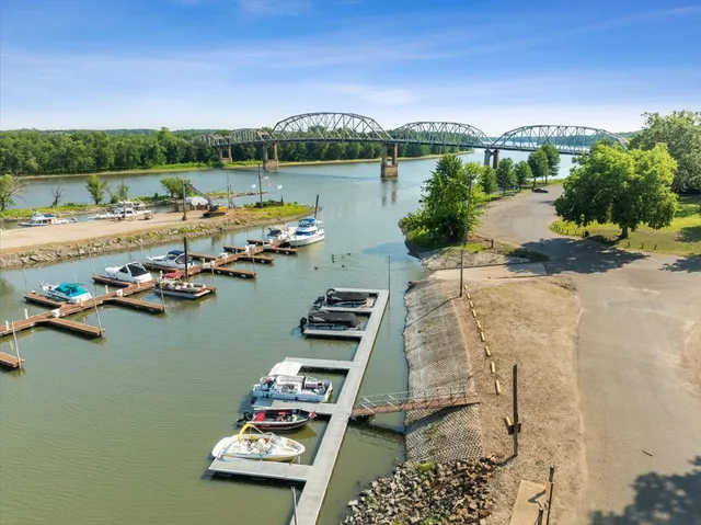 a view of a lake with boats and trees in the background