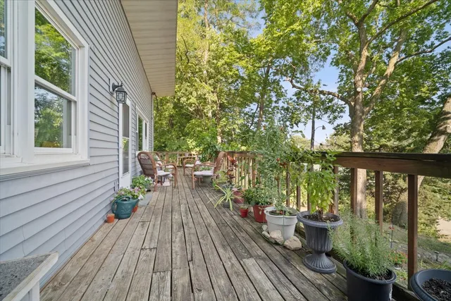 a view of balcony with chairs and wooden floor