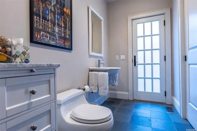 a bathroom with a toilet a sink and a window