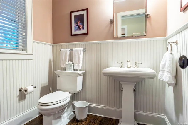a bathroom with a sink toilet and a mirror