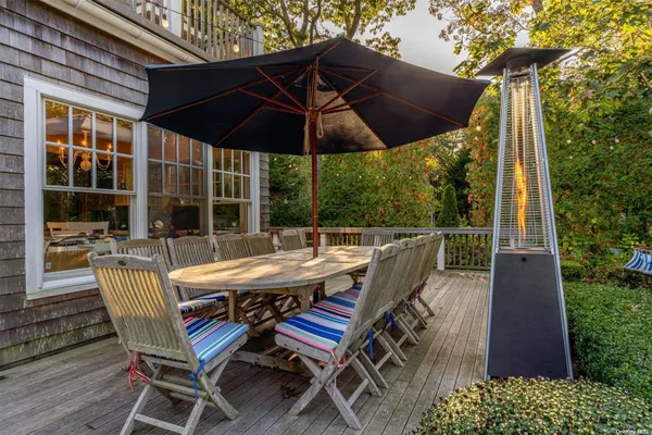 a view of an outdoor sitting area with furniture and wooden deck