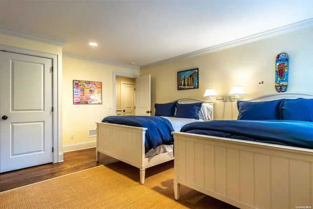 a spacious bedroom with two beds and a window