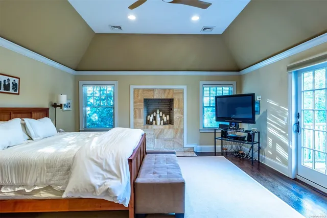 a bed room with a bed television and a large window