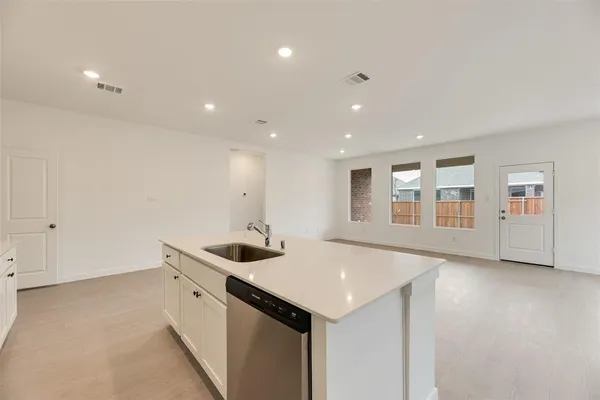 a kitchen with stainless steel appliances granite countertop a sink and cabinets