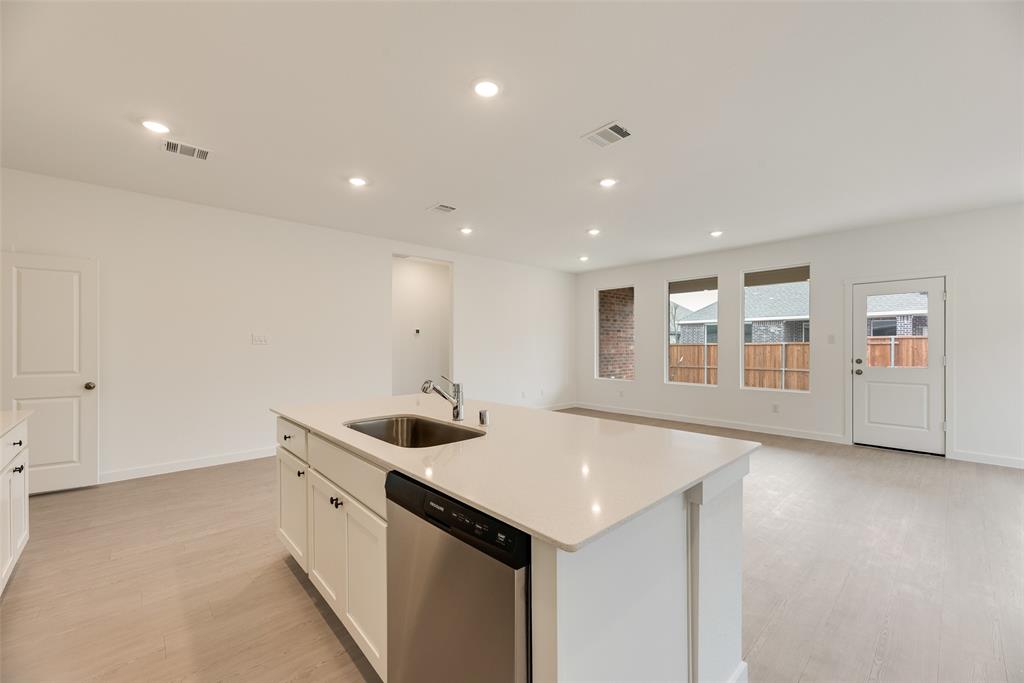 2416 Conroe Road Celina, TX 75009 - Photo 12 of 28 a kitchen with stainless steel appliances granite countertop a sink and cabinets