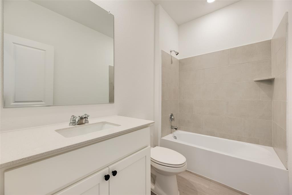 2416 Conroe Road Celina, TX 75009 - Photo 18 of 28 a bathroom with a sink a toilet and shower