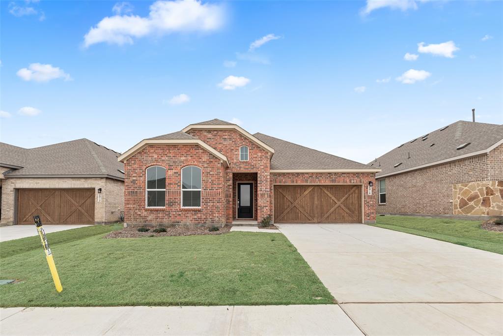 2416 Conroe Road Celina, TX 75009 - Photo 2 of 28 a front view of a house with a garden and yard