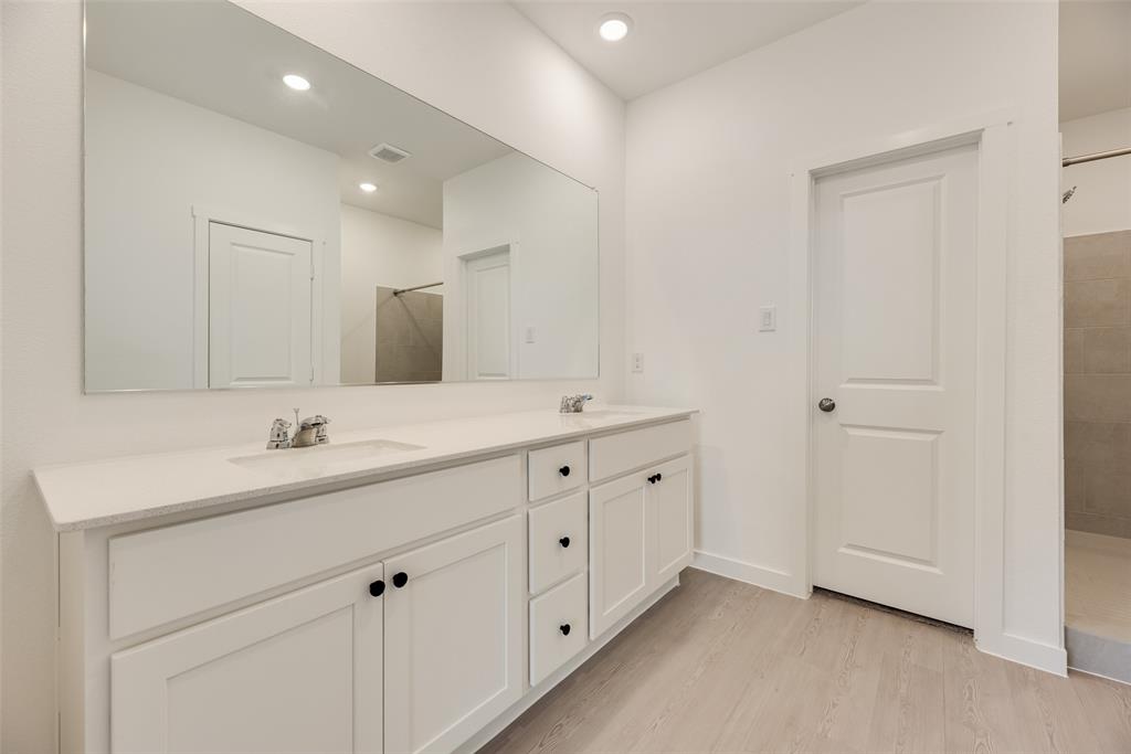 2416 Conroe Road Celina, TX 75009 - Photo 23 of 28 a bathroom with a double vanity sink and mirror