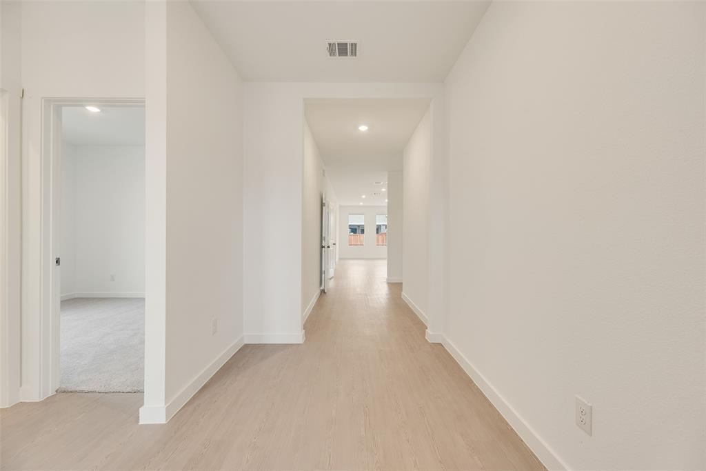 2416 Conroe Road Celina, TX 75009 - Photo 4 of 28 a view of a hallway with a wooden shelves