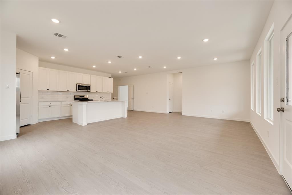 2416 Conroe Road Celina, TX 75009 - Photo 6 of 28 a view of kitchen with white cabinets and stainless steel appliances