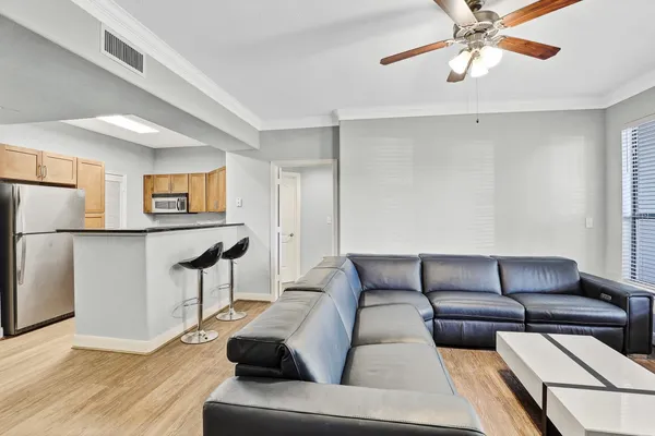 a living room with furniture and a wooden floor