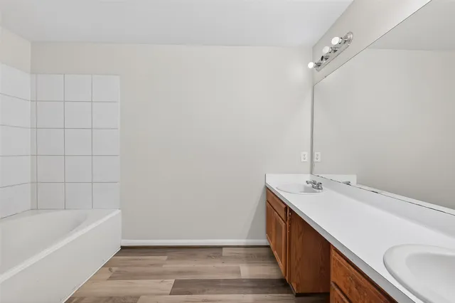 a bathroom with a double vanity sink and mirror