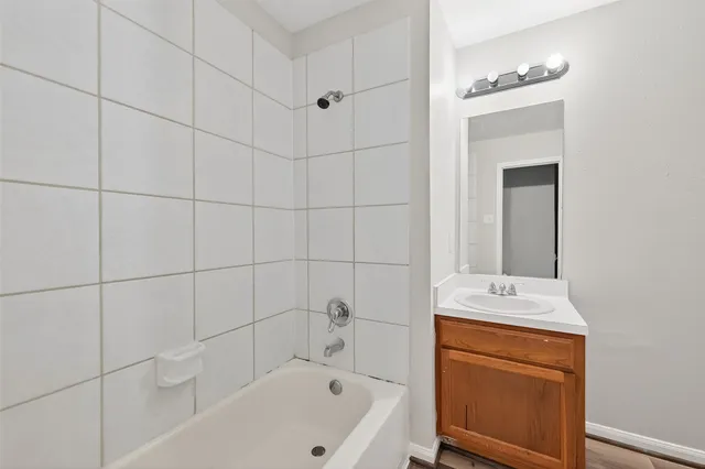 a bathroom with a bathtub and a sink