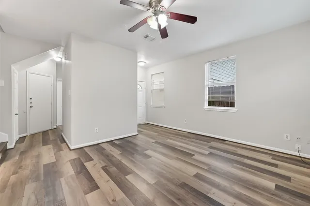wooden floor in an empty room with a window