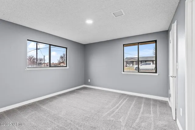 a view of empty room with windows