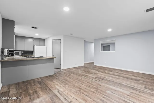 a large kitchen with kitchen island a sink stainless steel appliances and cabinets