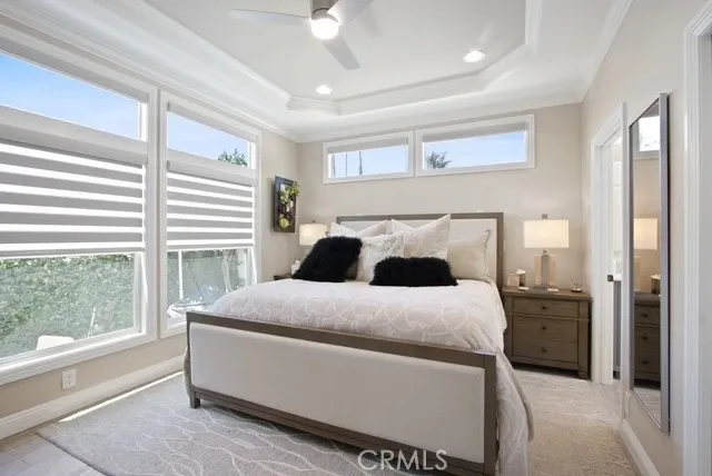 a bedroom with a bed and a large window