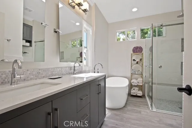 a spacious bathroom with a granite countertop sink and a mirror