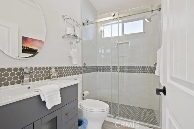 a bathroom with a sink toilet and shower