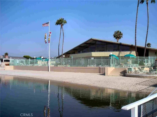 a view of house with a yard and sitting area