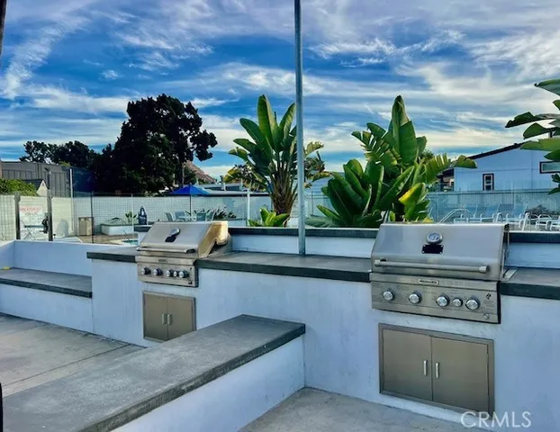 a kitchen with stainless steel appliances kitchen island a stove and a cabinets