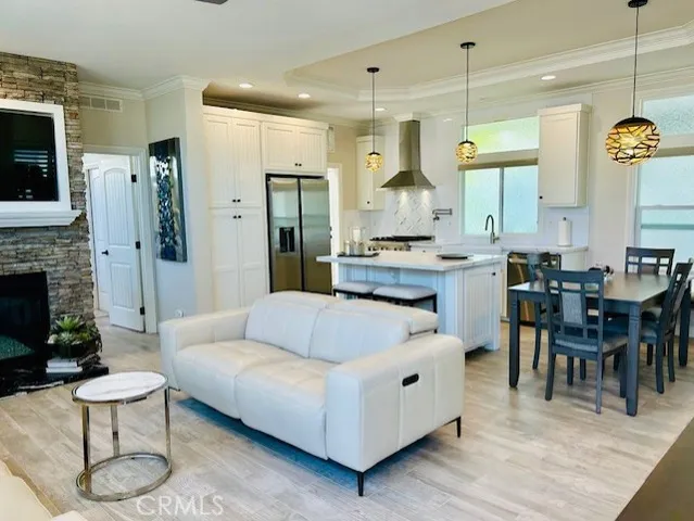 a living room with furniture kitchen view and a fireplace