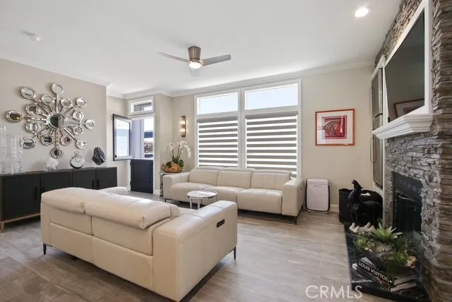 a living room with furniture fireplace and flat screen tv