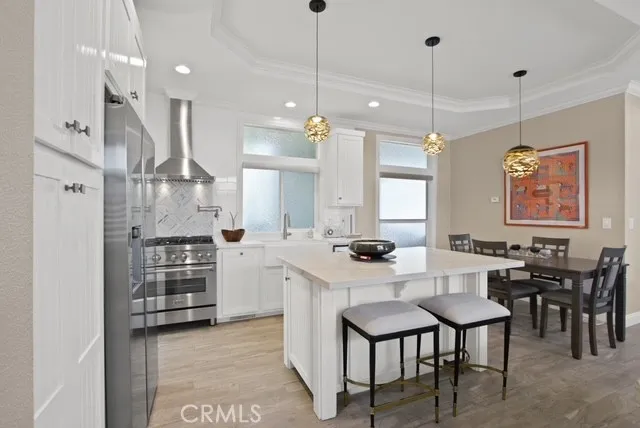 a large kitchen with a table and chairs
