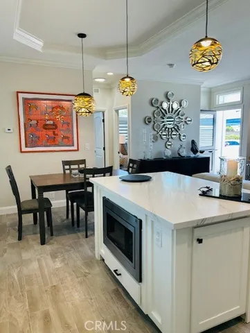 a kitchen with a stove a kitchen island a dining table and chairs