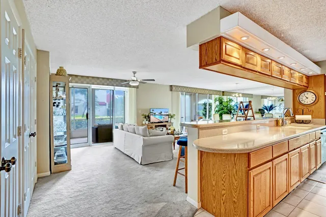 a kitchen with stainless steel appliances granite countertop a sink a stove and a refrigerator