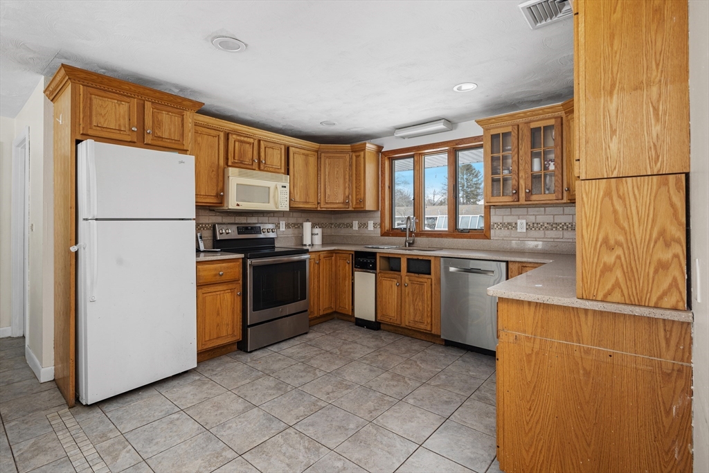 5 Richard Road Hingham, MA 02043 - Photo 2 of 12 a kitchen with stainless steel appliances granite countertop a refrigerator a stove a sink dishwasher and a refrigerator