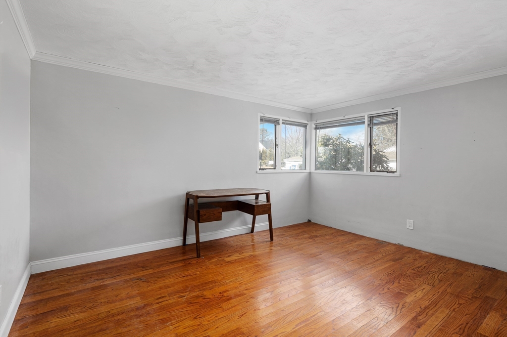 5 Richard Road Hingham, MA 02043 - Photo 7 of 12 a view of an empty room with wooden floor and a window