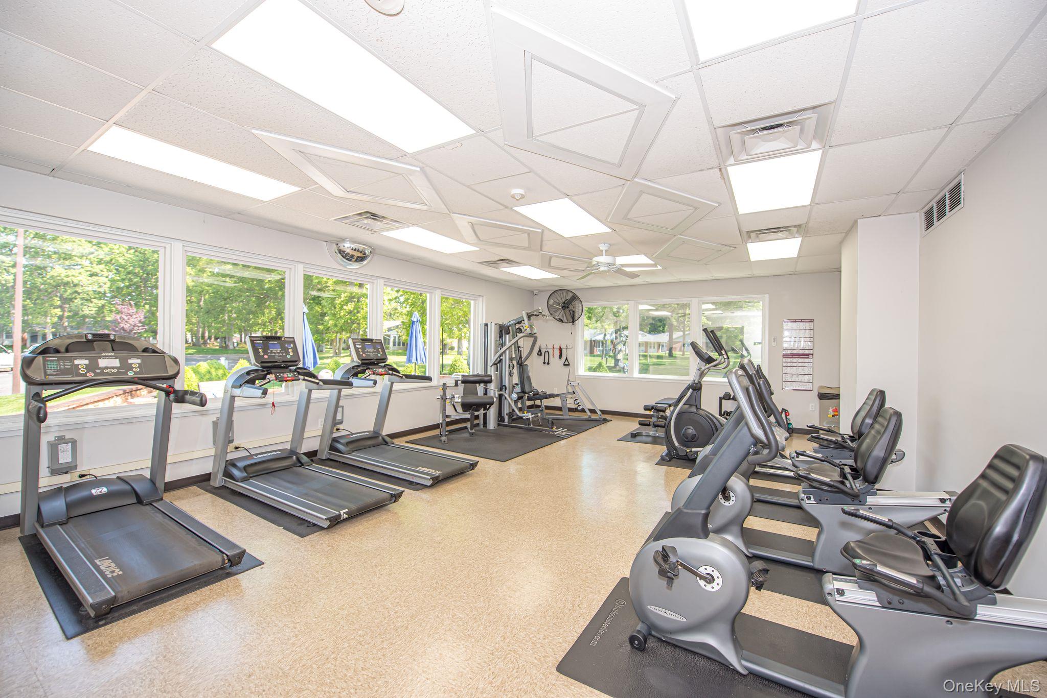 312 Woodbridge Drive, Unit C Ridge, NY 11961 - Photo 11 of 12 a view of a room with gym equipment