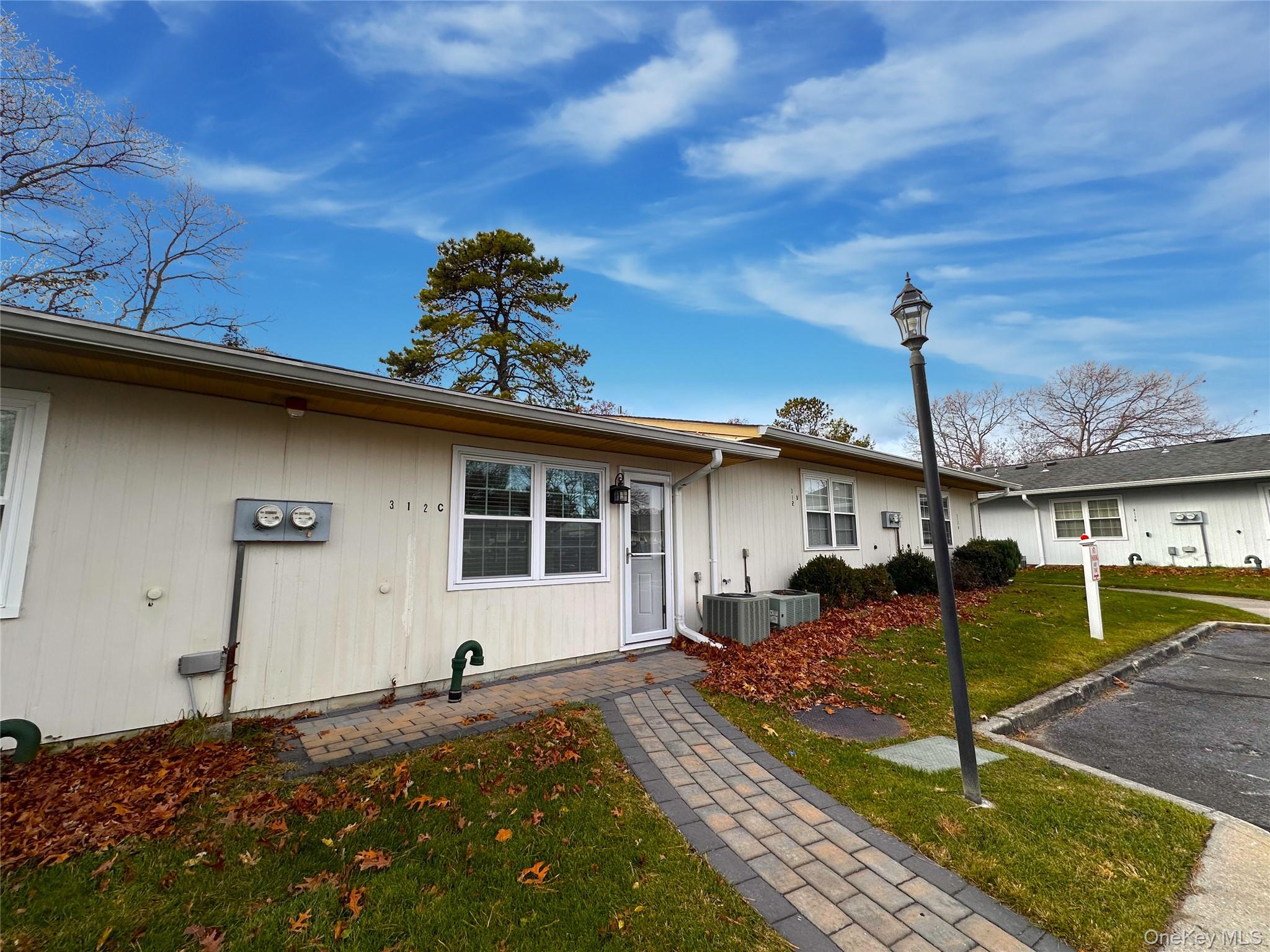 312 Woodbridge Drive, Unit C Ridge, NY 11961 - Photo 12 of 12 a house view with a backyard space