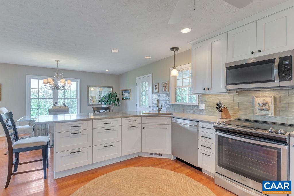 205 Old Stony Ridge Road Afton, VA 22920 - Photo 18 of 70 a kitchen with stainless steel appliances granite countertop a stove a sink and a microwave