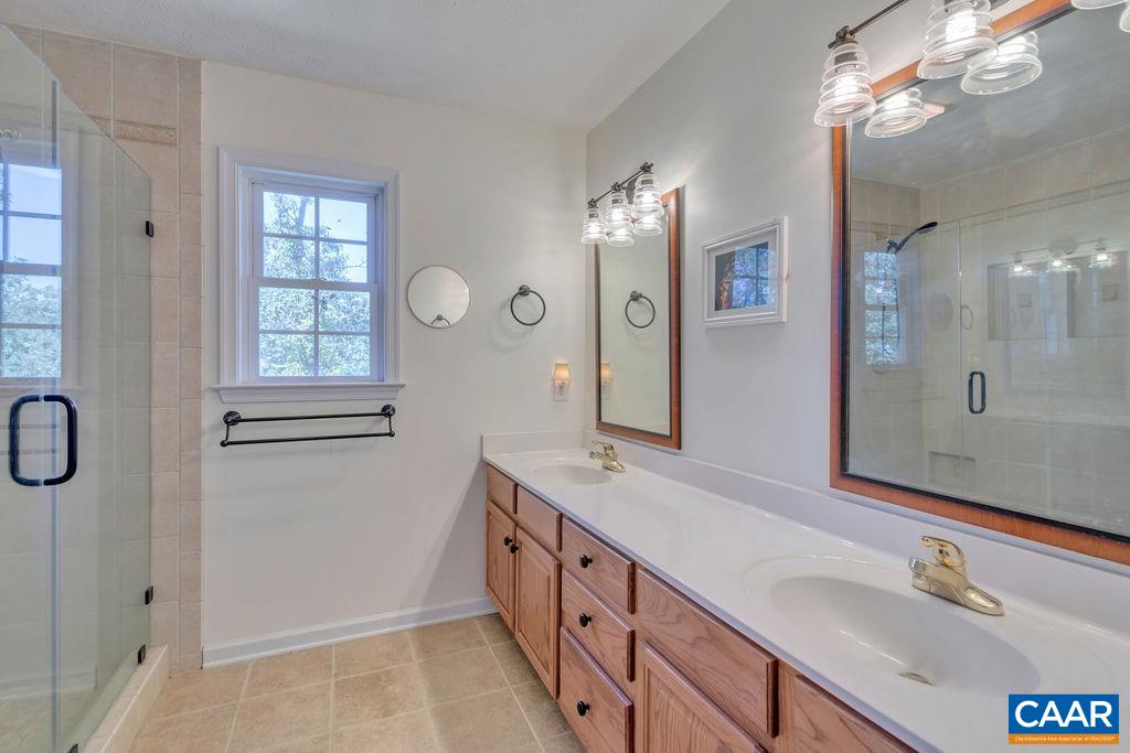 205 Old Stony Ridge Road Afton, VA 22920 - Photo 26 of 70 a bathroom with a double vanity sink mirror and shower