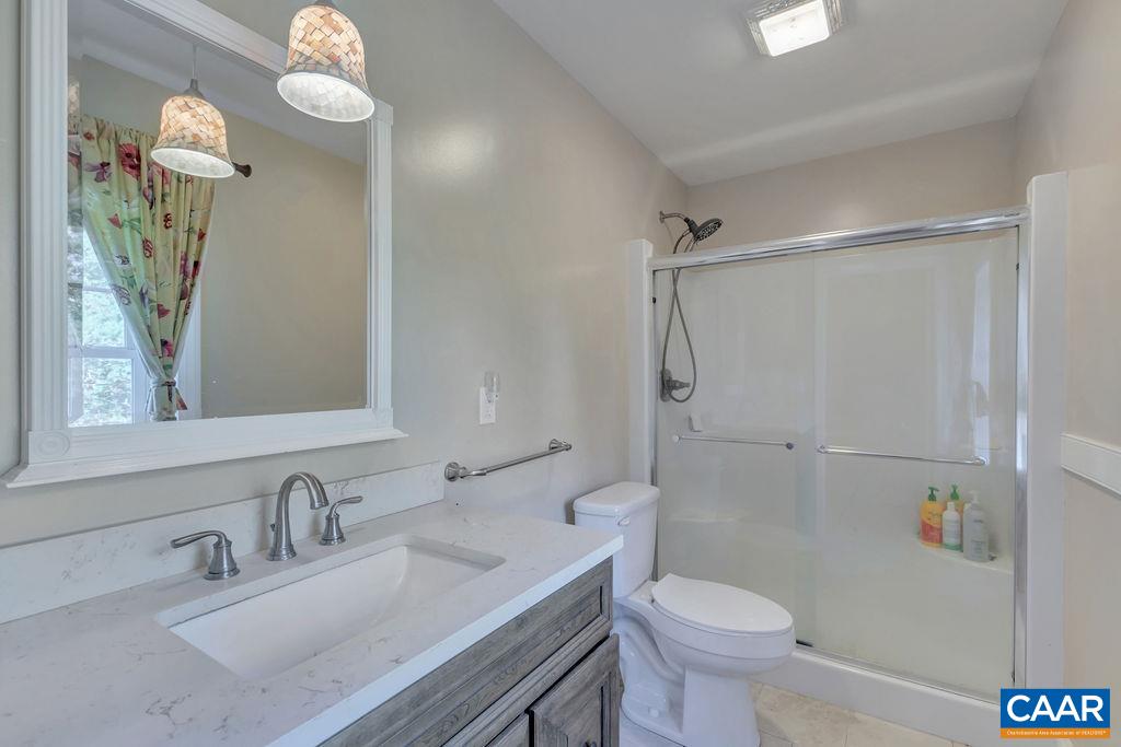 205 Old Stony Ridge Road Afton, VA 22920 - Photo 39 of 70 a bathroom with a granite countertop sink toilet and shower