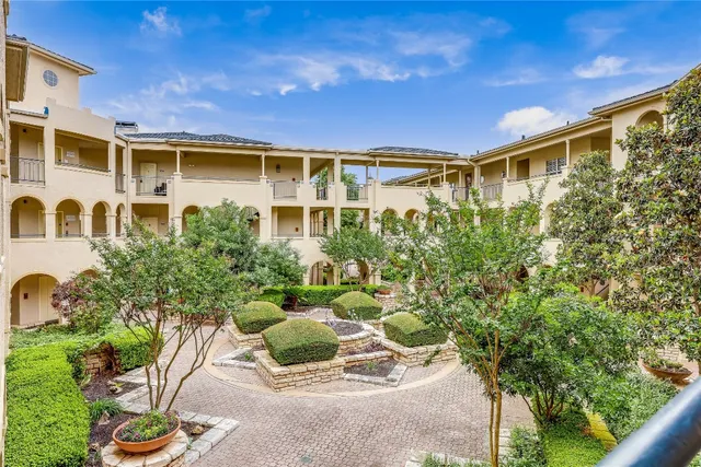 a view of a patio with table and chairs and potted plants