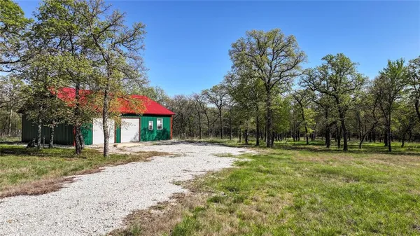 a backyard of a house with lots of green space and trees